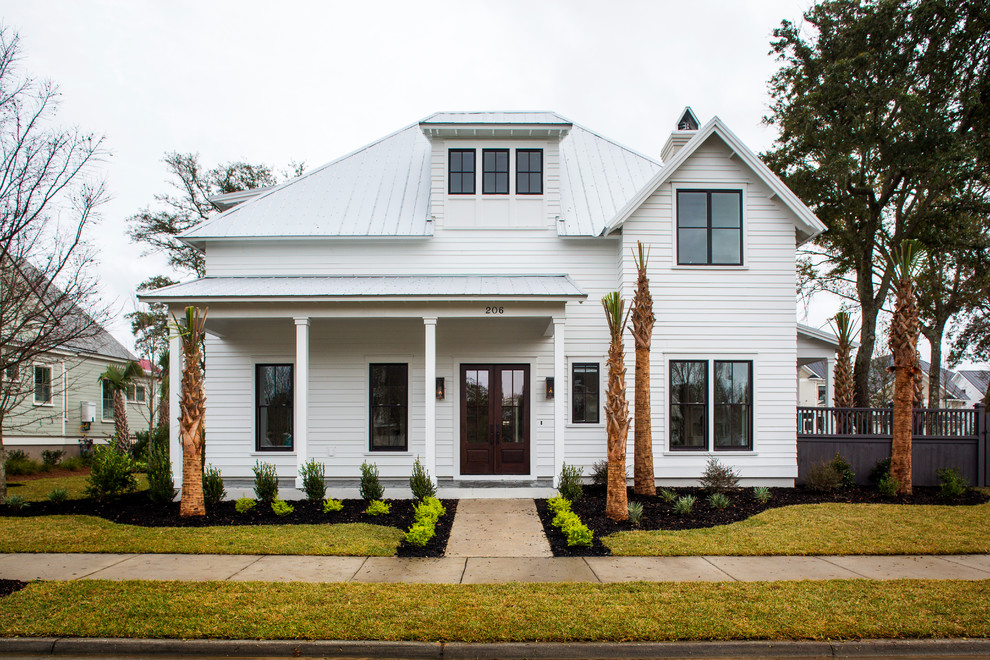 This is an example of a large and white modern two floor house exterior in Charleston with a hip roof and concrete fibreboard cladding.