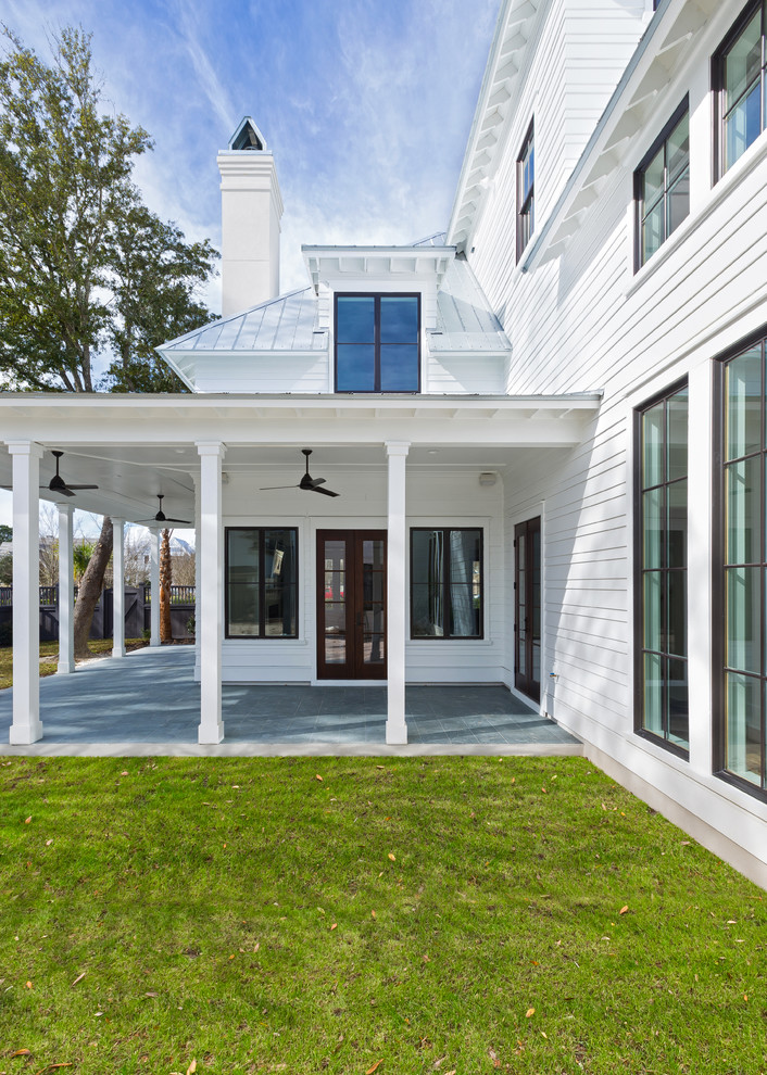 Example of a large cottage white two-story concrete fiberboard gable roof design in Charleston