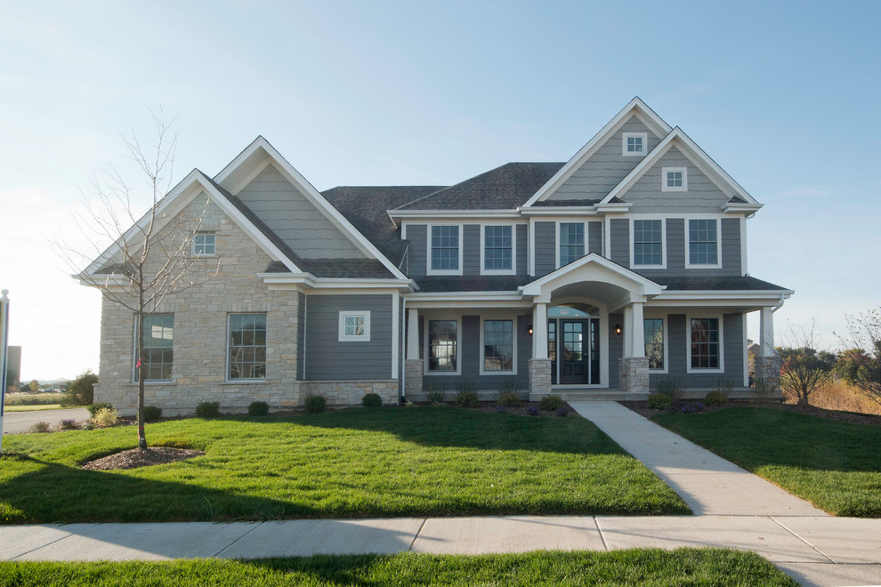 Large elegant gray two-story mixed siding exterior home photo in Chicago with a shingle roof