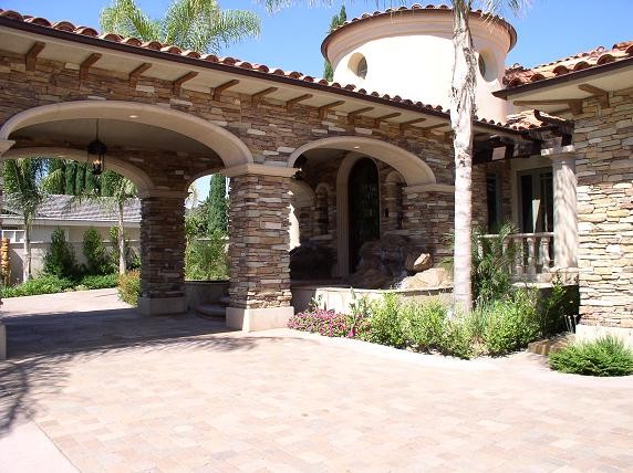 Inspiration for a huge mediterranean beige two-story mixed siding house exterior remodel in Orange County with a tile roof