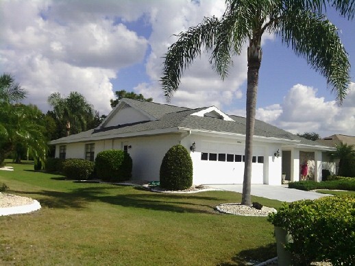 Large elegant white two-story mixed siding gable roof photo in Tampa