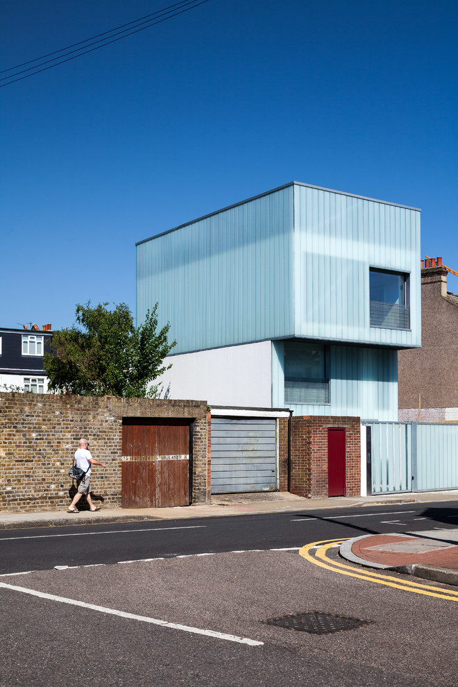 Inspiration for a contemporary two-story flat roof remodel in London