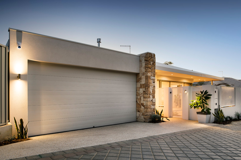 Medium sized and white modern bungalow house exterior in Perth with mixed cladding.