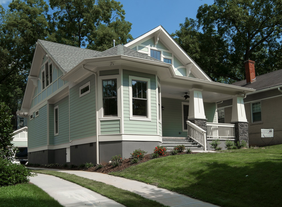 Пример оригинального дизайна: зеленый, одноэтажный дом среднего размера в классическом стиле с облицовкой из ЦСП и двускатной крышей