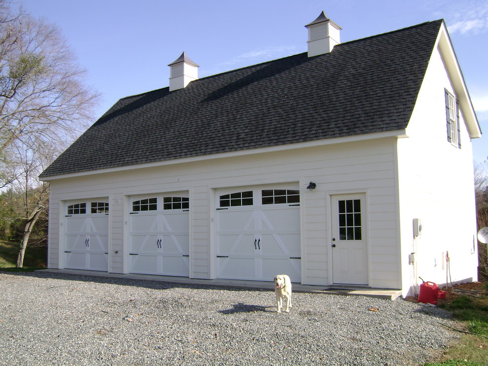 This is an example of a medium sized traditional detached garage in Other with three or more cars.