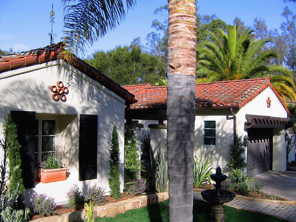 Inspiration for a white and medium sized mediterranean bungalow render detached house in Santa Barbara with a half-hip roof and a tiled roof.