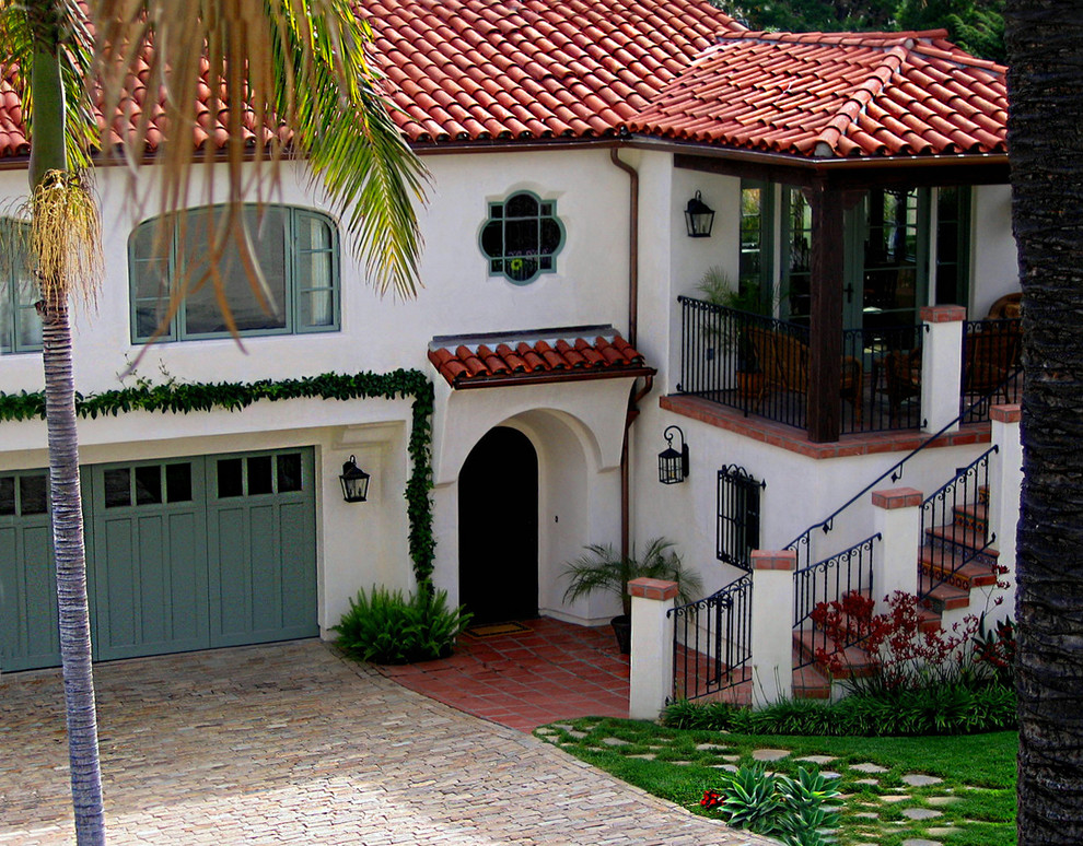 White and medium sized mediterranean two floor render detached house in Santa Barbara with a hip roof and a tiled roof.