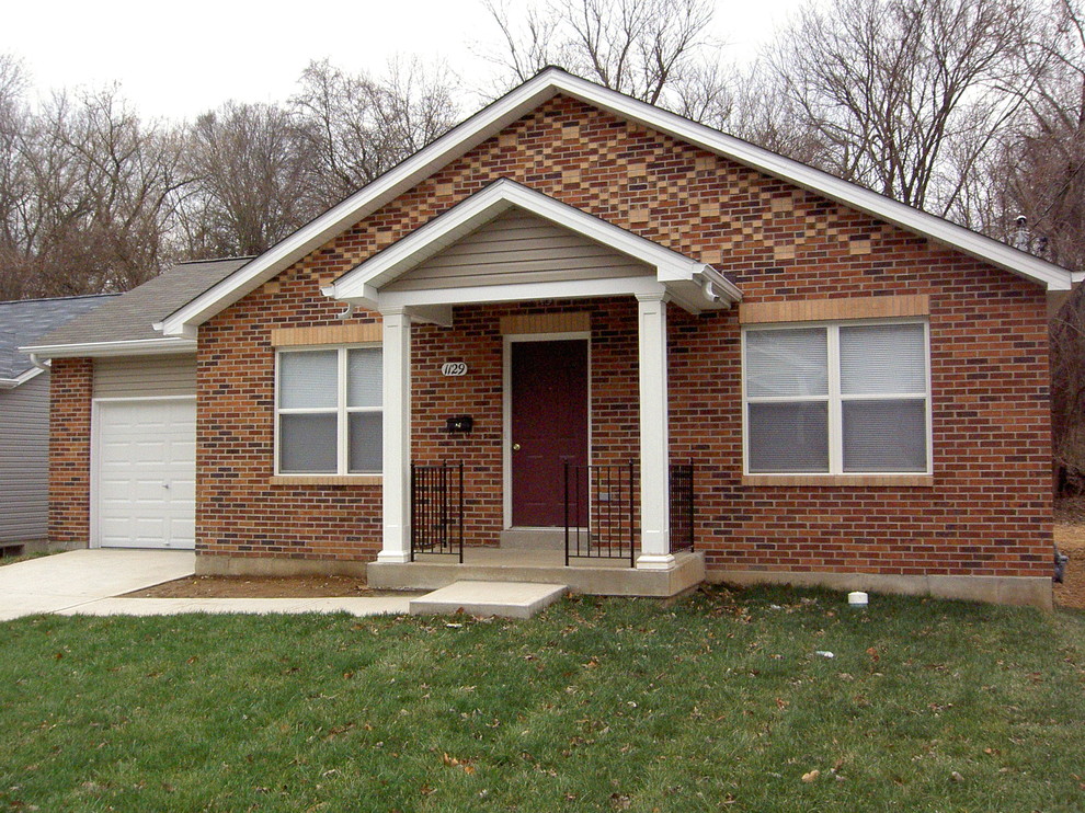 Small and beige classic bungalow brick house exterior in St Louis with a pitched roof.