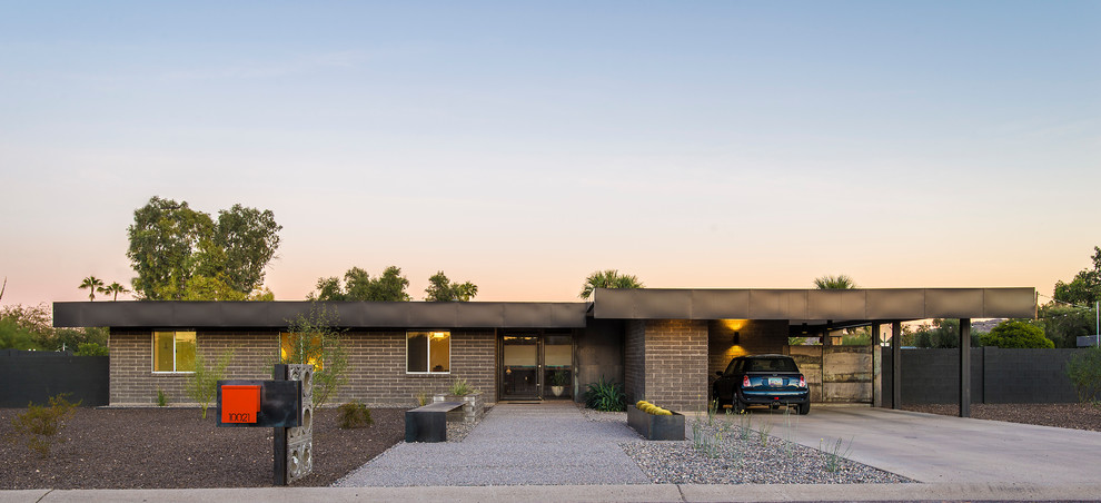 Expansive and gey retro bungalow concrete house exterior in Phoenix with a flat roof.