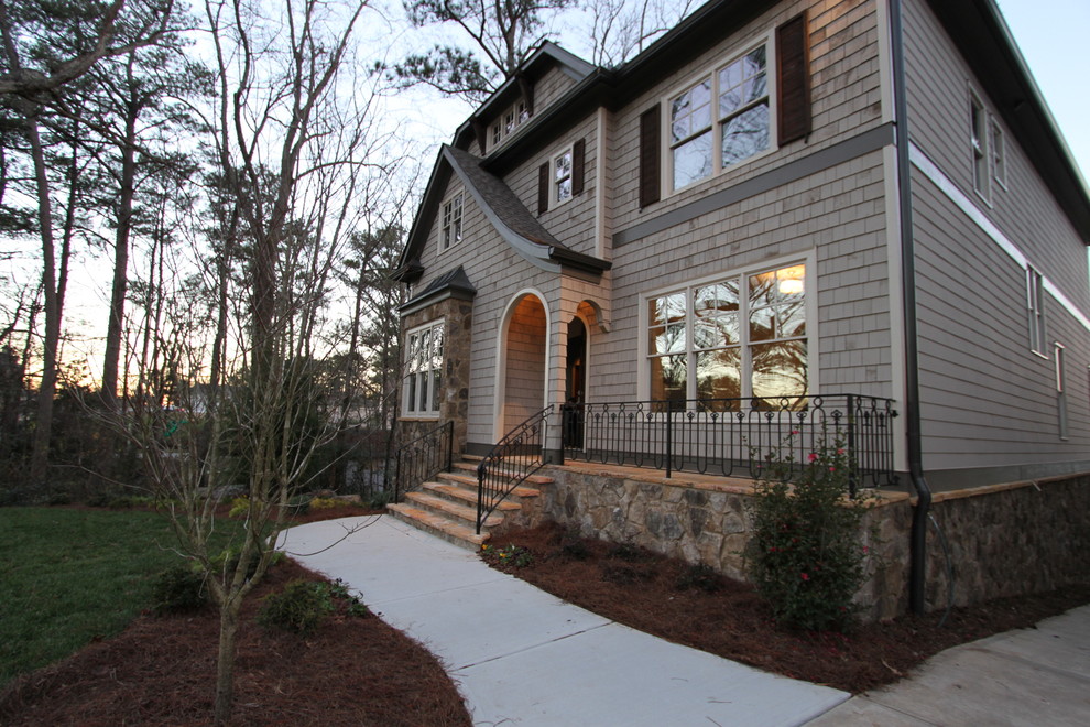 Large elegant gray two-story wood exterior home photo in Atlanta with a clipped gable roof