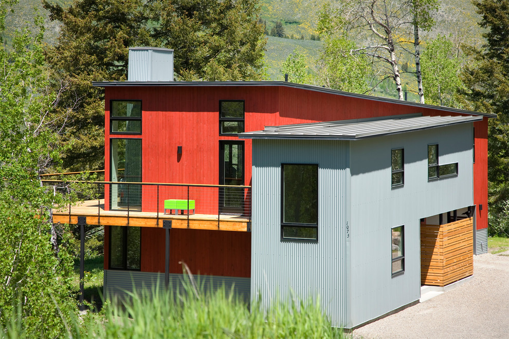 Example of a mid-sized trendy multicolored two-story mixed siding exterior home design in Other with a metal roof