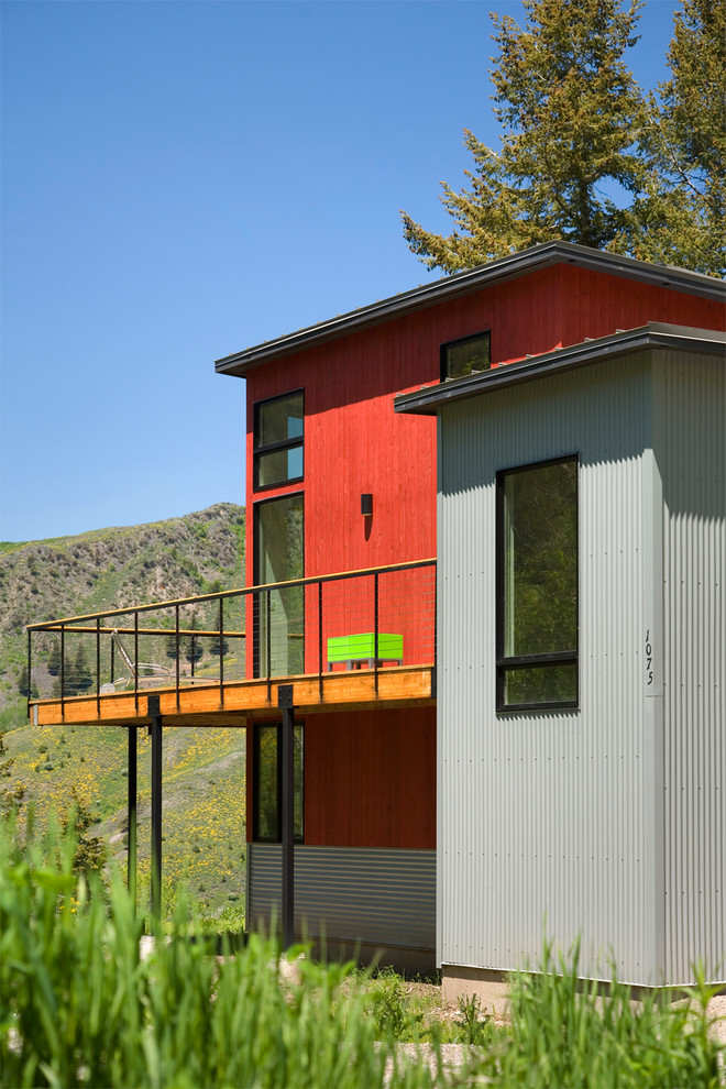 Diseño de fachada de casa multicolor actual de tamaño medio de dos plantas con revestimientos combinados, tejado plano y tejado de metal