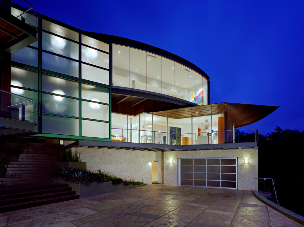 White and large contemporary glass detached house in Austin with three floors, a flat roof and a metal roof.