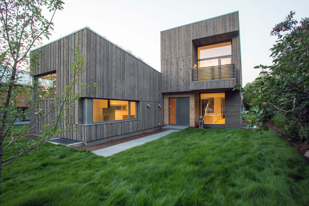 Inspiration for a large and brown modern two floor detached house in Denver with wood cladding, a flat roof and a green roof.