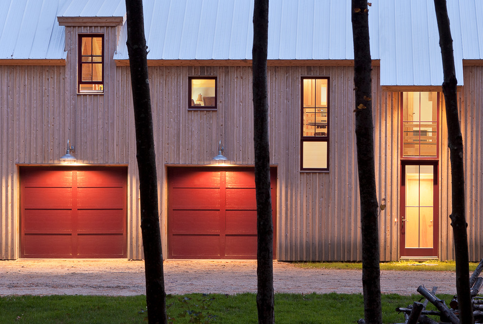 Réalisation d'une façade de maison beige champêtre en bois à un étage avec un toit à deux pans et un toit en métal.