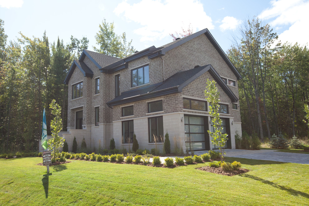 Inspiration for a large contemporary gray two-story brick gable roof remodel in Montreal