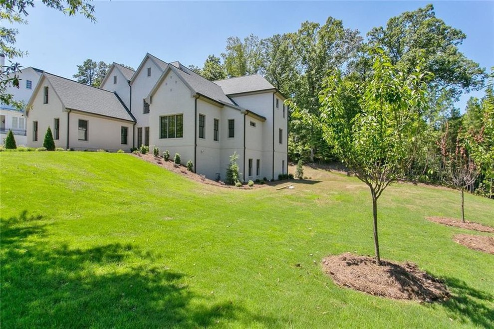 Large transitional gray two-story brick exterior home idea in Atlanta with a shingle roof