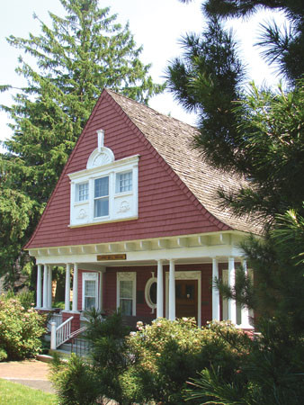 Example of a small classic red two-story wood exterior home design in Grand Rapids