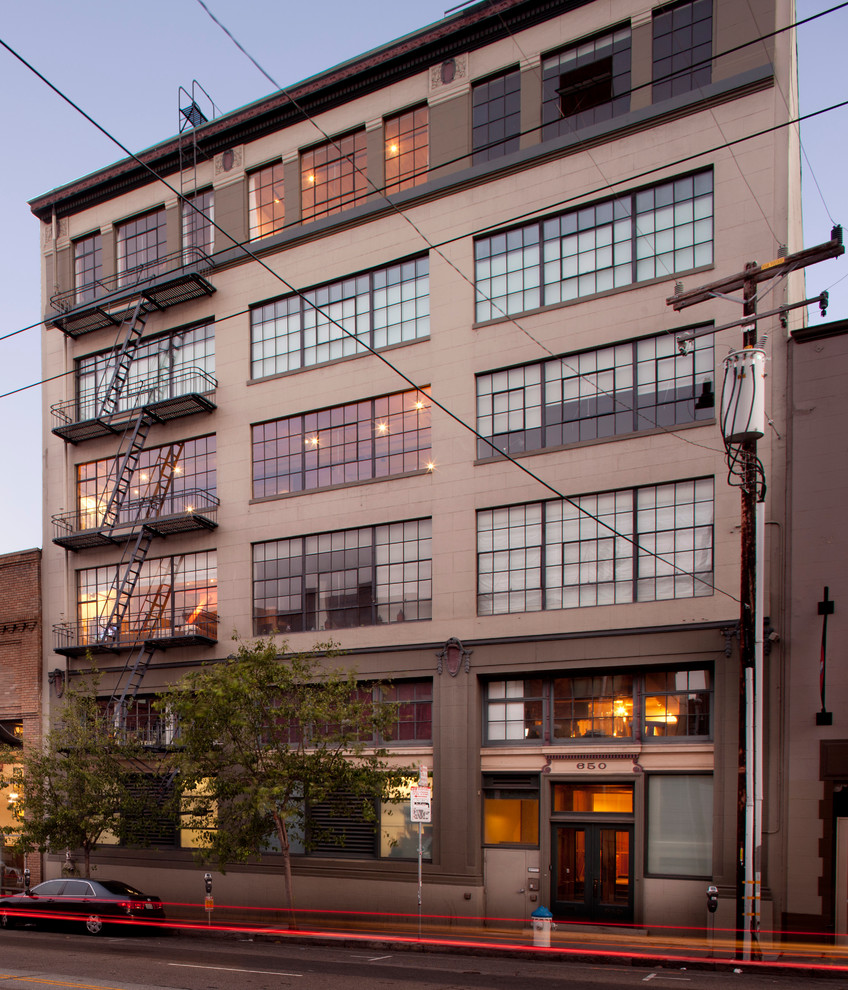 Inspiration for a small industrial beige one-story concrete exterior home remodel in San Francisco