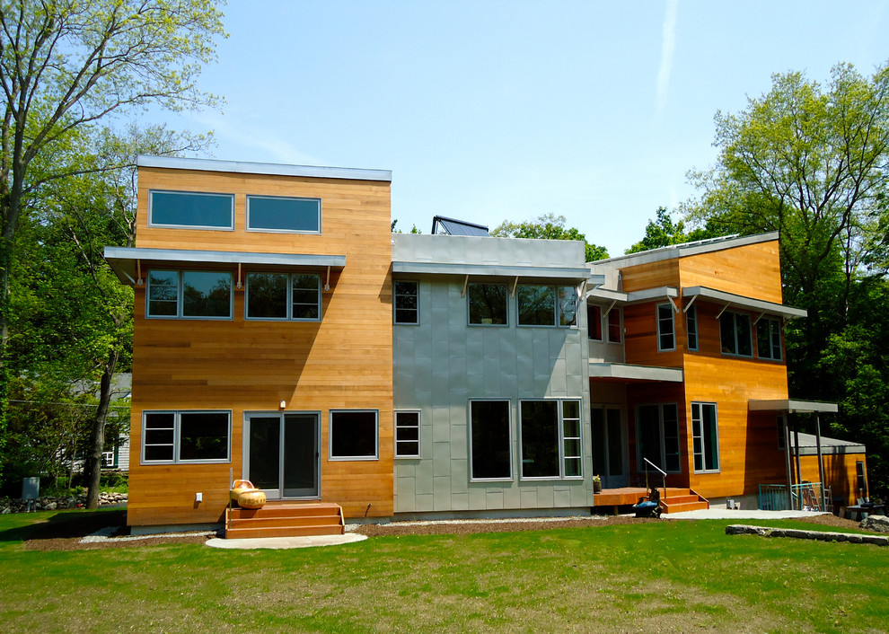 Inspiration for a large contemporary brown two-story mixed siding exterior home remodel in Boston with a metal roof