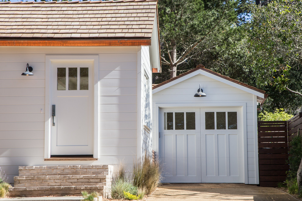 This is an example of a small and white modern bungalow house exterior in San Francisco with wood cladding.