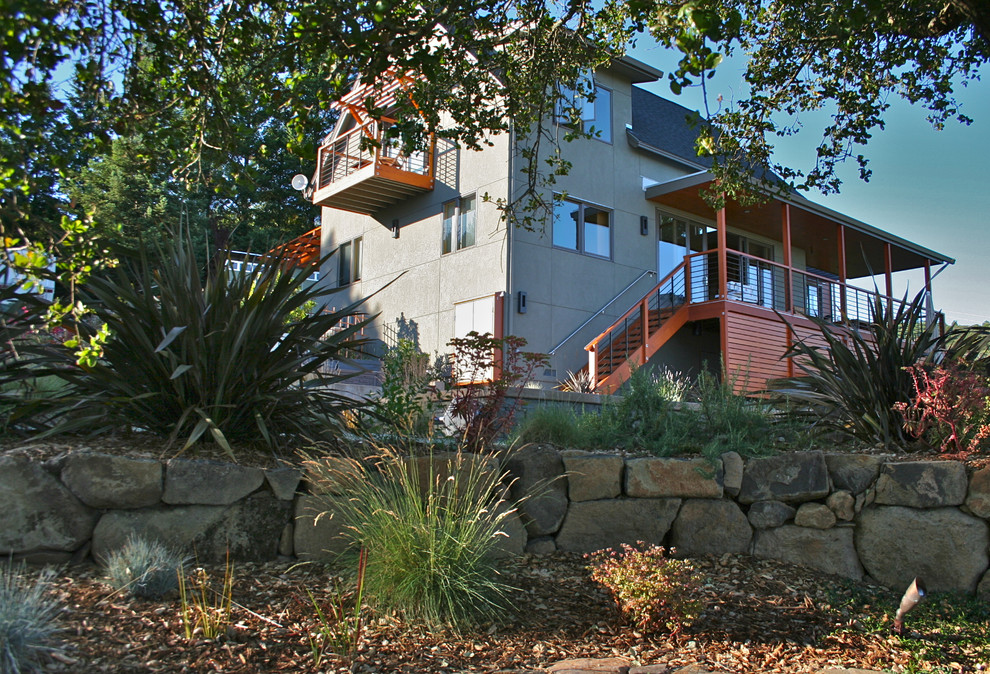 Example of a large trendy gray two-story concrete exterior home design in San Francisco with a shingle roof
