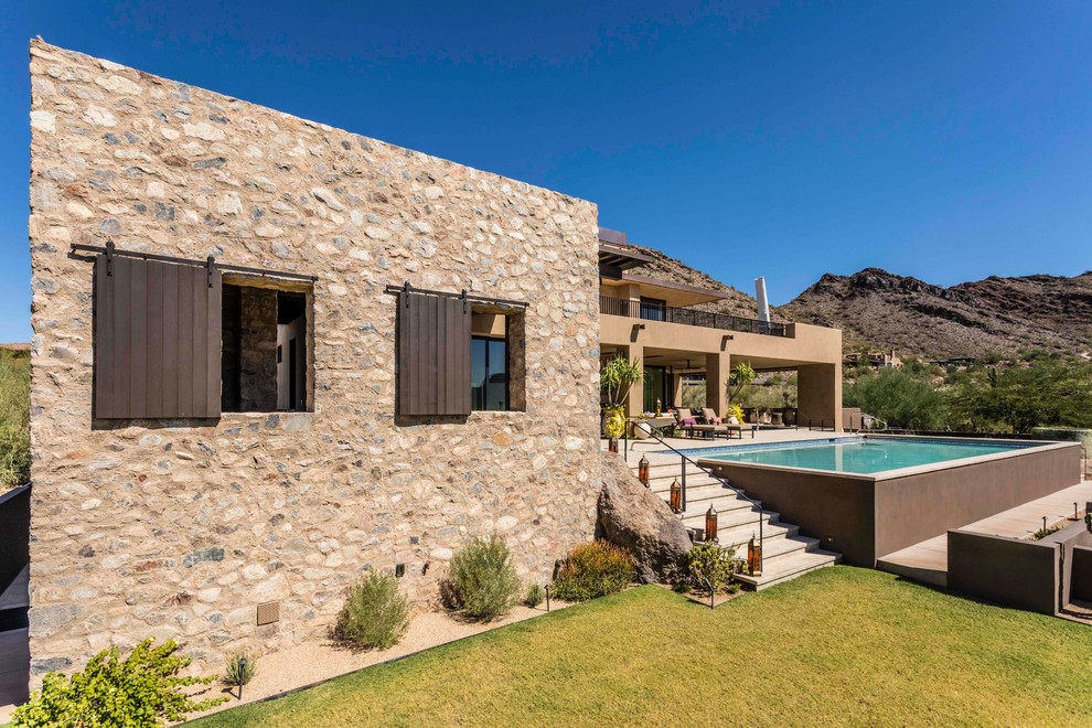 Design ideas for a brown detached house in Phoenix with stone cladding.