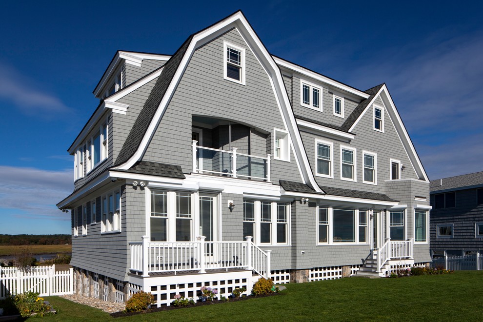 Photo of a gey and large coastal house exterior in Portland Maine with three floors and wood cladding.