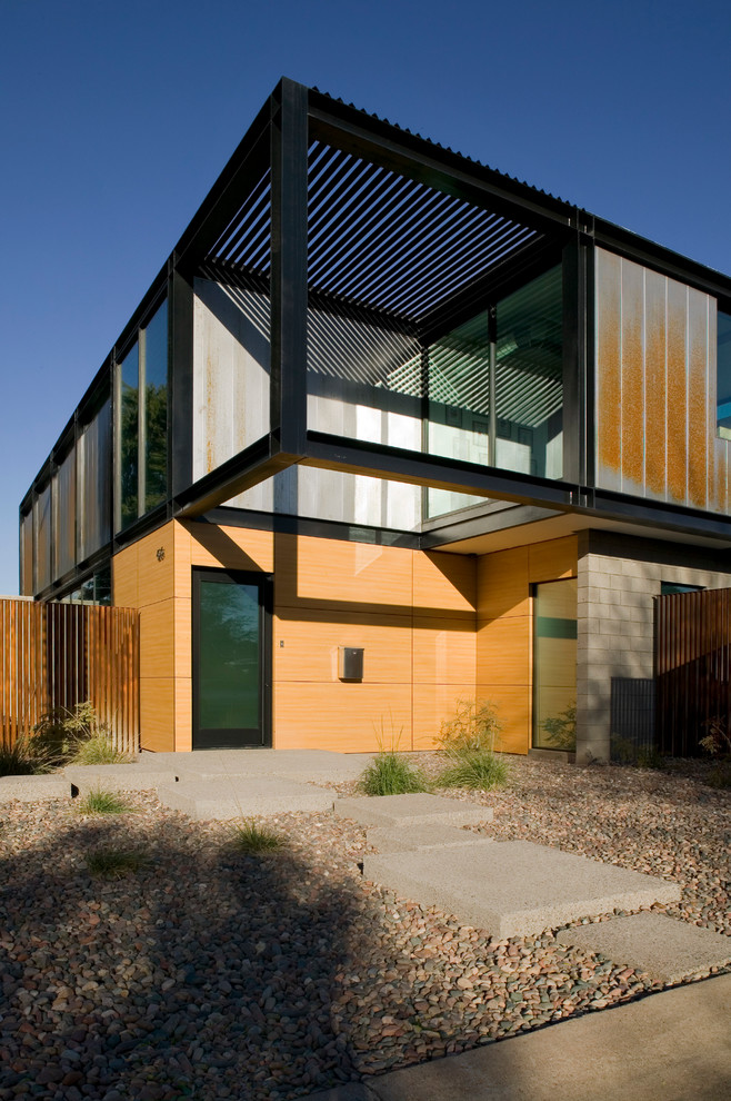 На фото: двухэтажный, серый дом среднего размера в стиле модернизм с облицовкой из металла и плоской крышей с