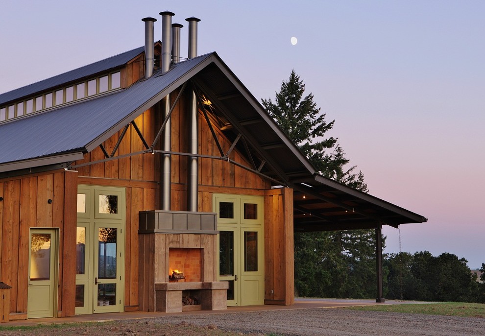 Example of a mountain style wood exterior home design in Portland