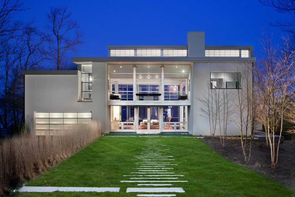 Large and gey modern house exterior in DC Metro with three floors, metal cladding and a flat roof.