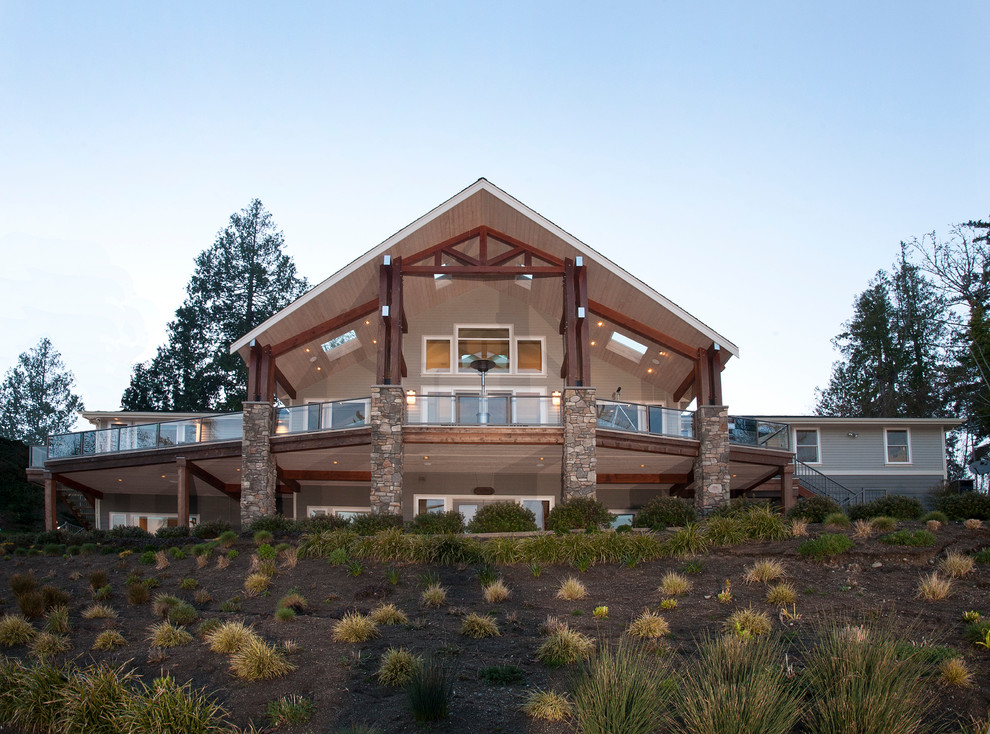 Large traditional beige three-story wood gable roof idea in Seattle
