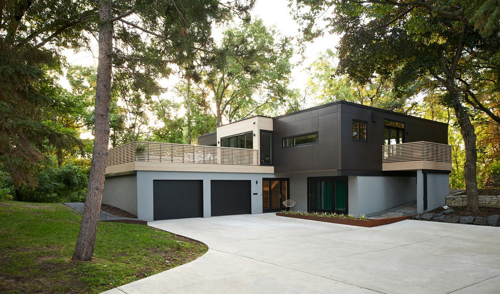Пример оригинального дизайна: двухэтажный, большой дом в стиле модернизм с комбинированной облицовкой и плоской крышей