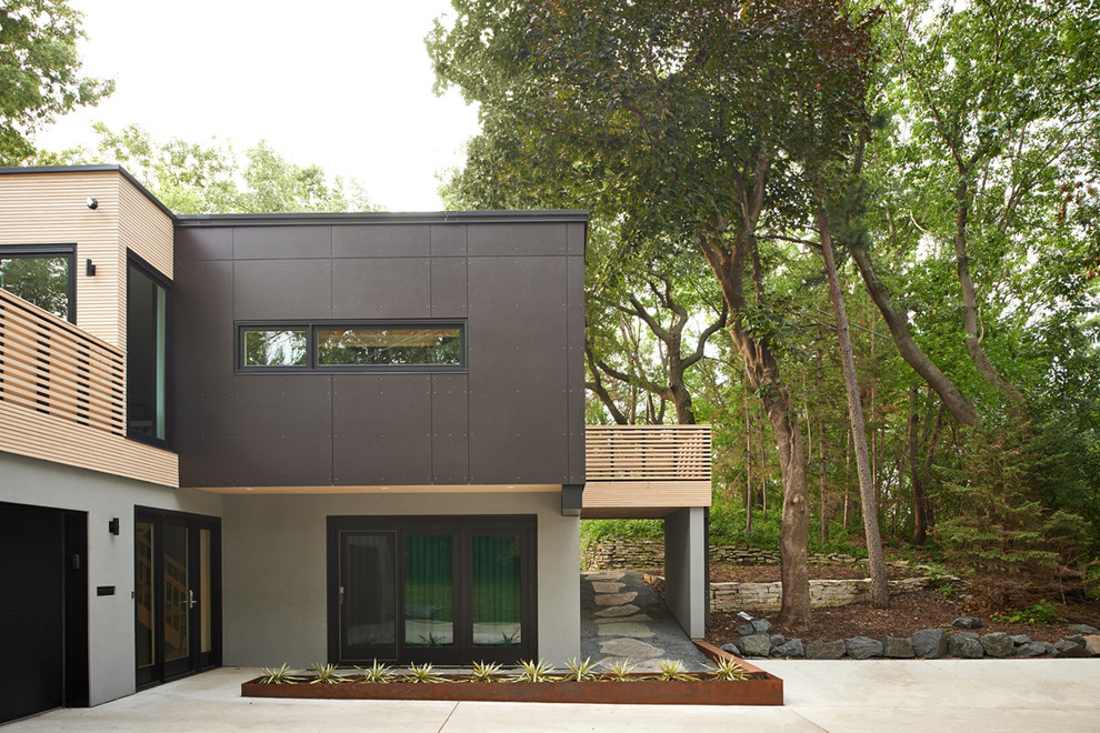 Diseño de fachada moderna de dos plantas con revestimientos combinados