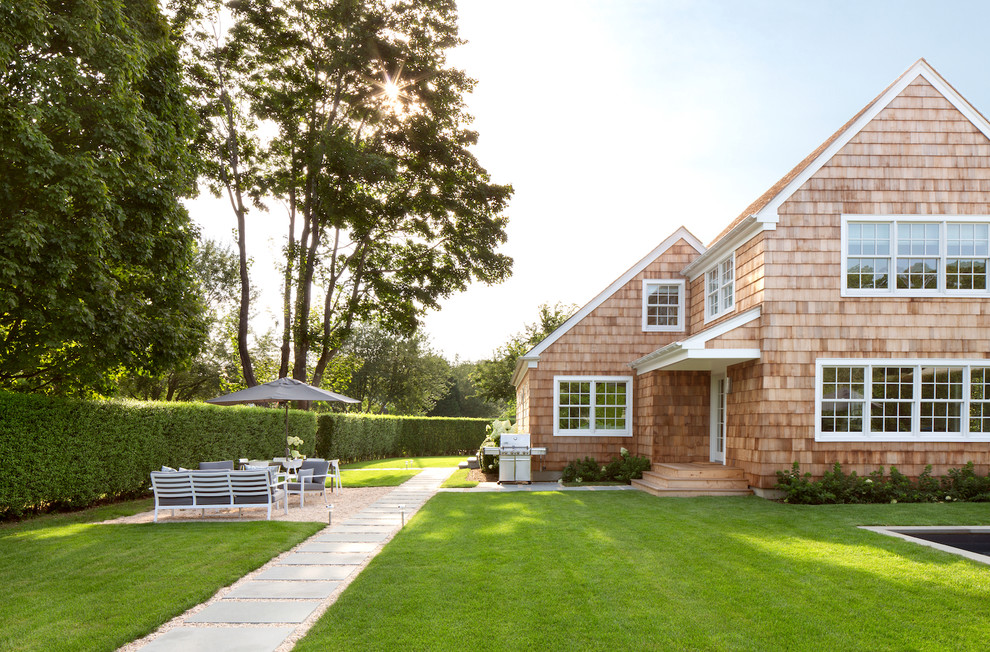 Mid-sized beach style brown two-story wood house exterior photo in New York