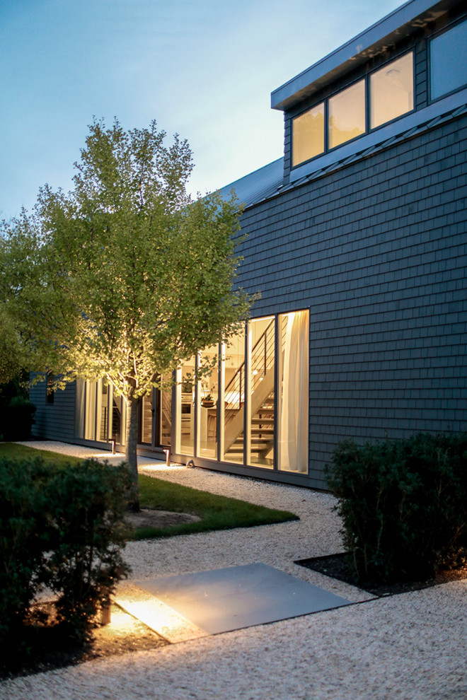 Diseño de fachada de casa gris contemporánea de tamaño medio de dos plantas con revestimiento de madera, tejado a la holandesa y tejado de metal