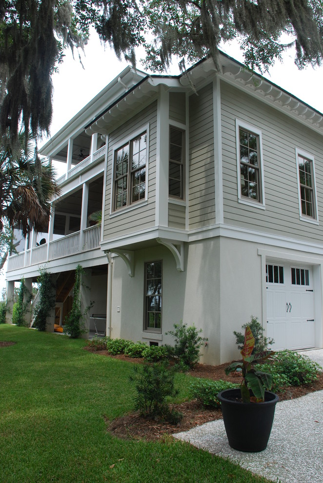 Example of a large classic beige three-story concrete fiberboard exterior home design in Charleston