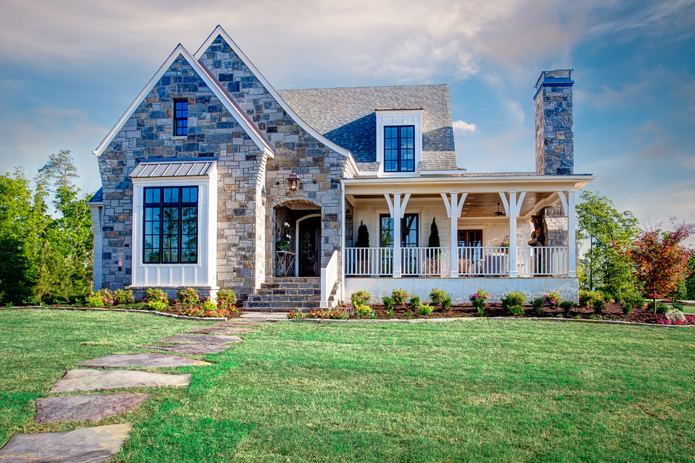 Medium sized traditional two floor house exterior in Little Rock with stone cladding.