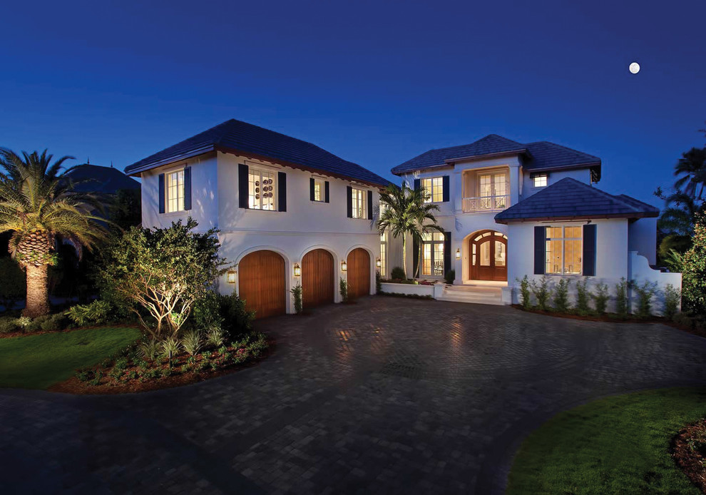 This is an example of a world-inspired two floor house exterior in Miami with a hip roof.