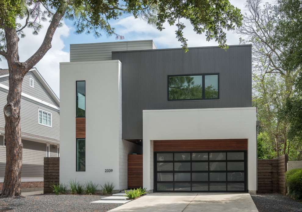 Inspiration for a mid-sized modern white two-story mixed siding exterior home remodel in Houston