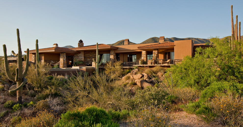 Large contemporary beige two-story mixed siding house exterior idea in Phoenix with a hip roof and a mixed material roof