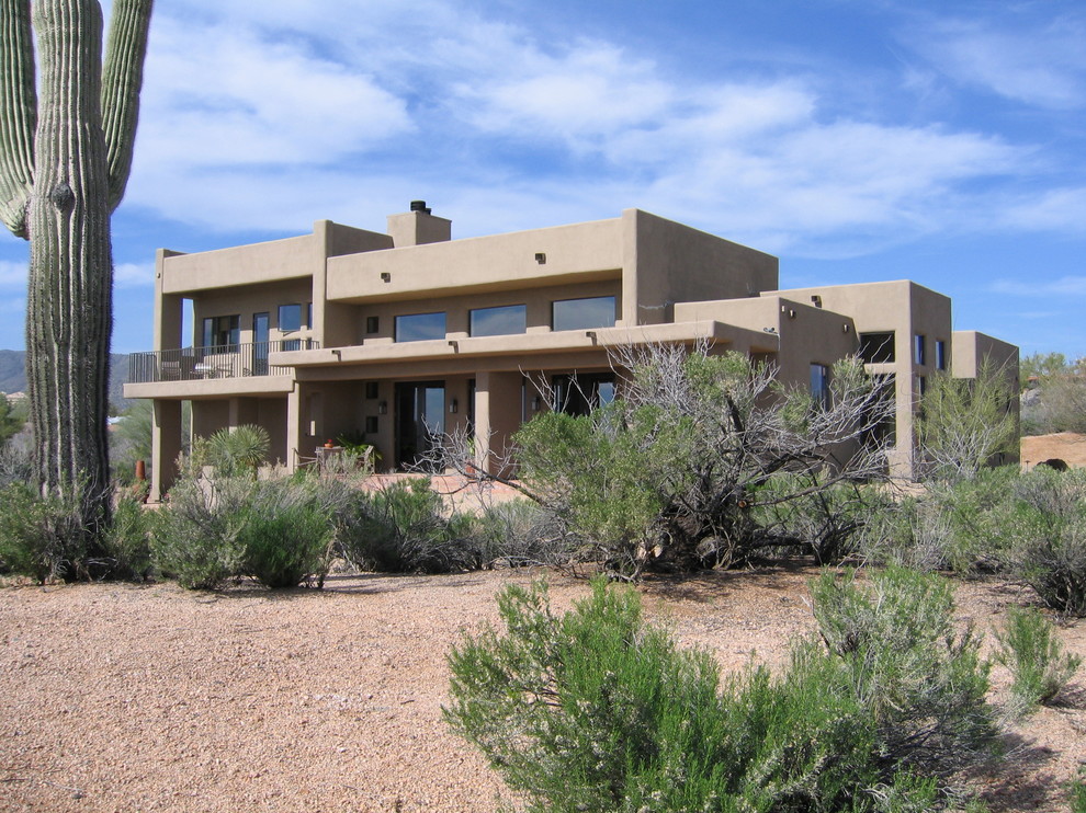 Design ideas for a medium sized two floor clay house exterior in Phoenix.