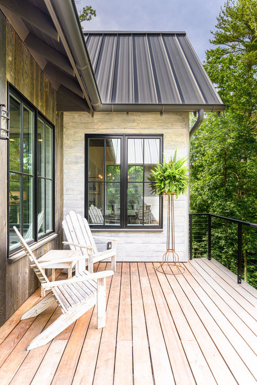 Inspiration for a rustic gray three-story mixed siding exterior home remodel in Other with a metal roof