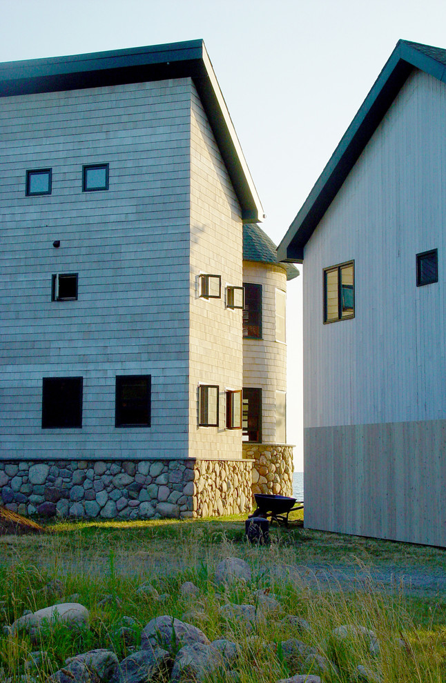 Photo of a farmhouse house exterior in Burlington with wood cladding.