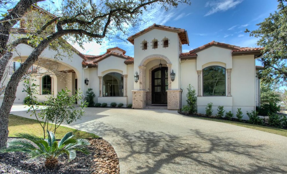 Example of a huge southwest white two-story exterior home design in Austin with a shingle roof