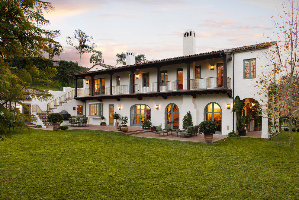 Inspiration for a white and large mediterranean two floor render house exterior in Santa Barbara with a pitched roof.