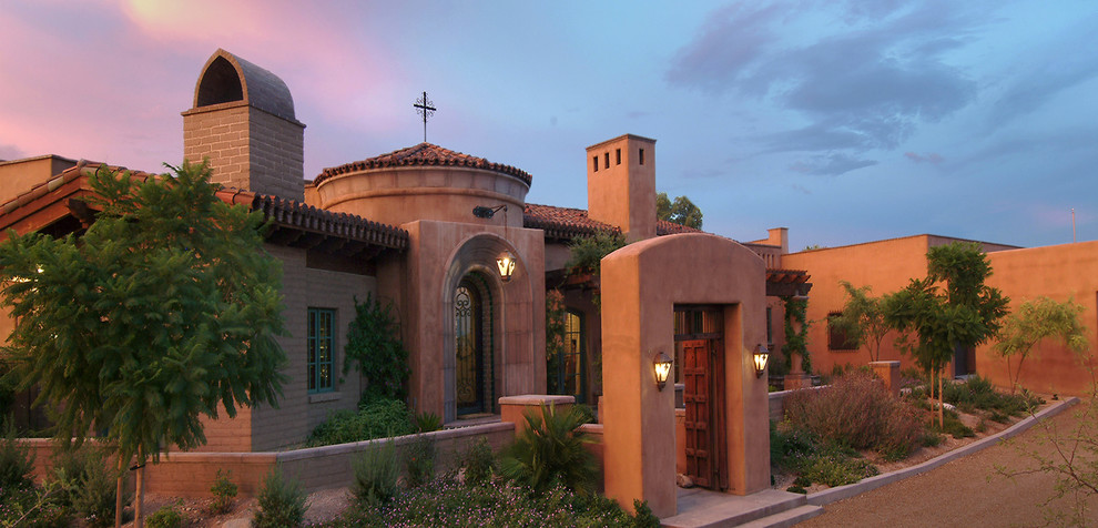 Inspiration for a mid-sized southwestern red one-story adobe gable roof remodel in Phoenix