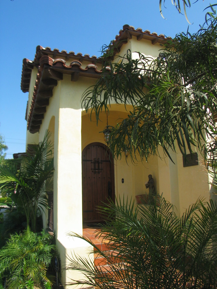 Example of a large tuscan two-story stucco exterior home design in San Diego