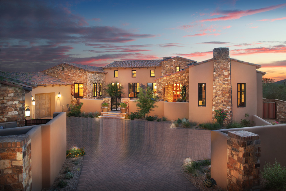 Large southwest brown one-story exterior home photo in Phoenix with a hip roof
