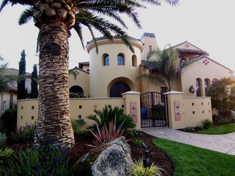 Inspiration for a large and beige mediterranean two floor render house exterior in Other.